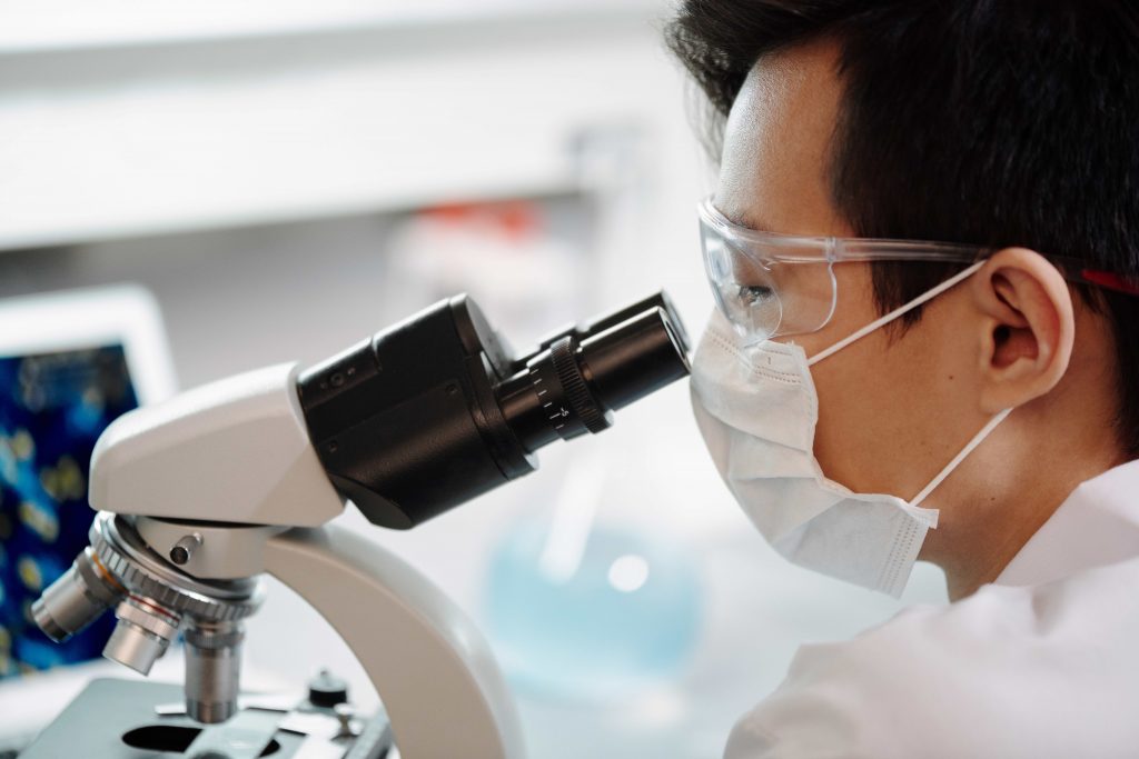 Man looking through a microscope.